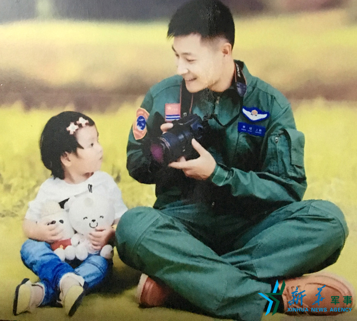 ↑資料圖片：被選為艦載戰(zhàn)斗機(jī)飛行員的張超與女兒合影。